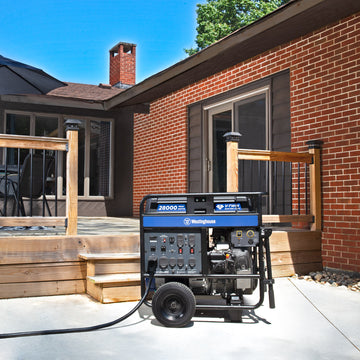 Westinghouse | WGen20000 portable generator shown sitting on the concrete with a back porch and house in the background
