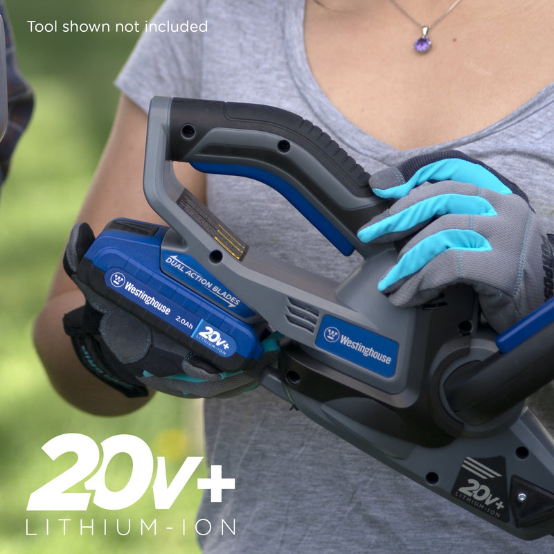 Woman holding Westinghouse cordless tool with battery in it 