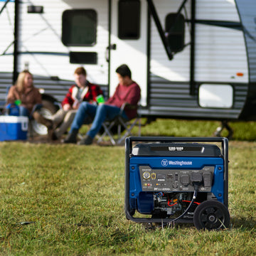 Westinghouse | WGen5300c portable generator is in the foreground. A camper with three people sitting outside of it are in the background.