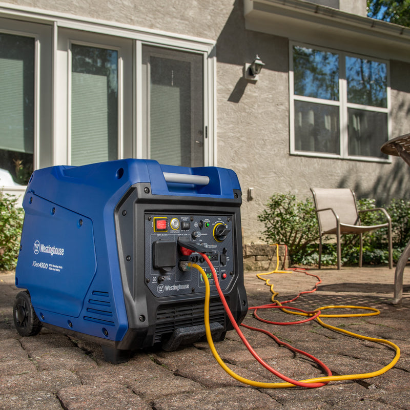 Westinghouse | iGen4500 inverter generator sitting on patio with cords plugged in.