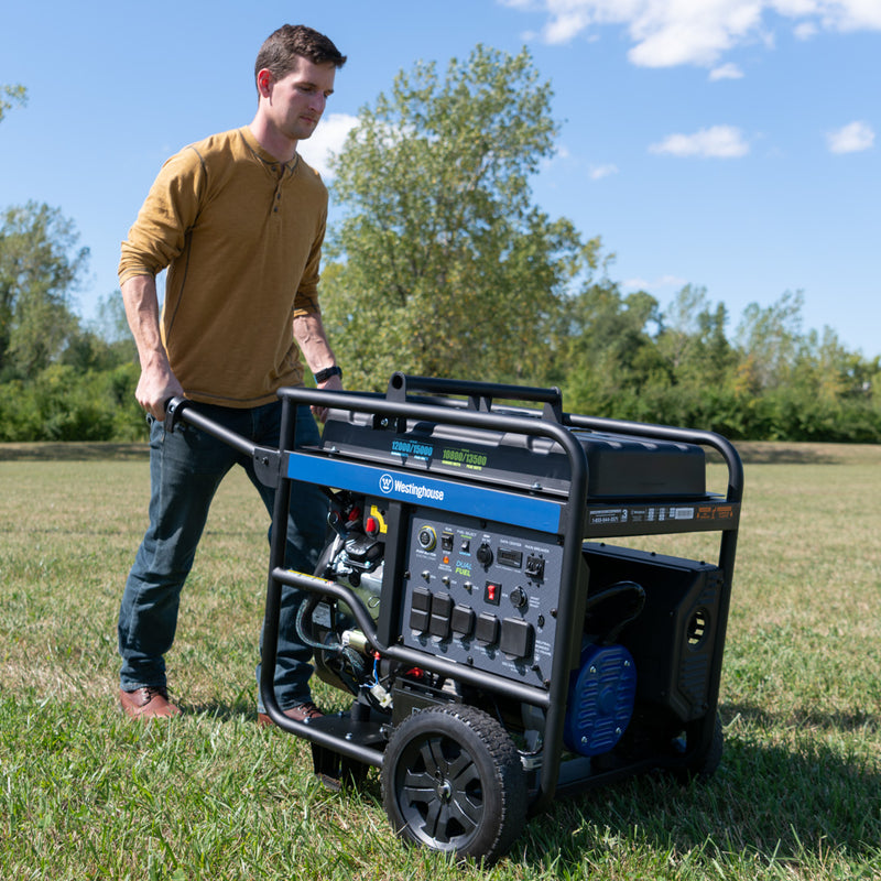 Westinghouse | WGen12000DF portable generator being wheeled across grass.