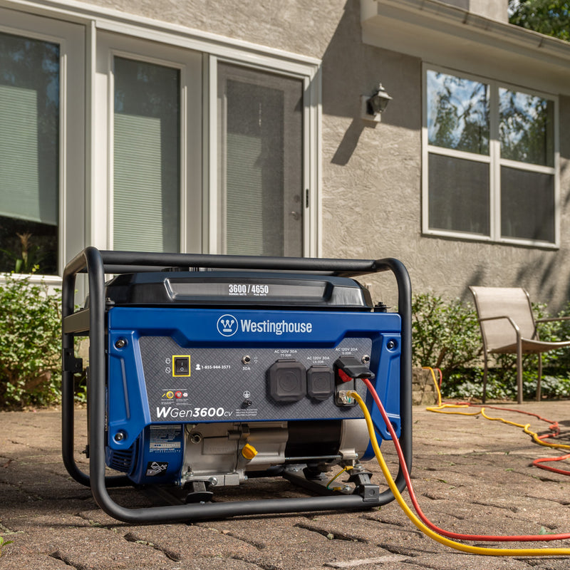 Westinghouse | WGen3600cv portable generator sitting on patio with cords plugged in.
