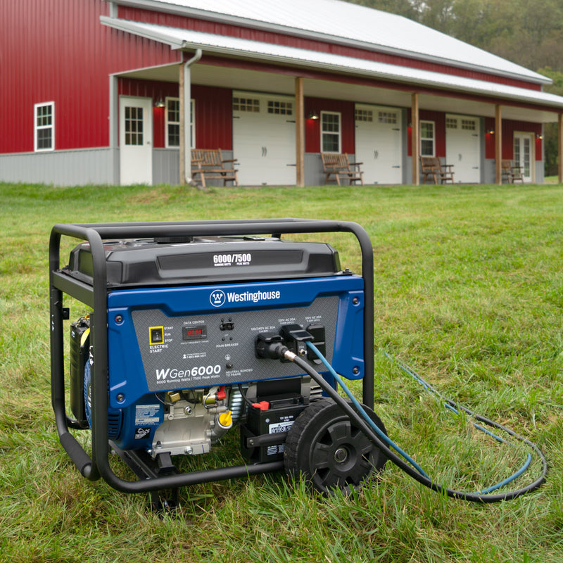 Westinghouse | WGen6000 portable generator sitting in grass outside of building.